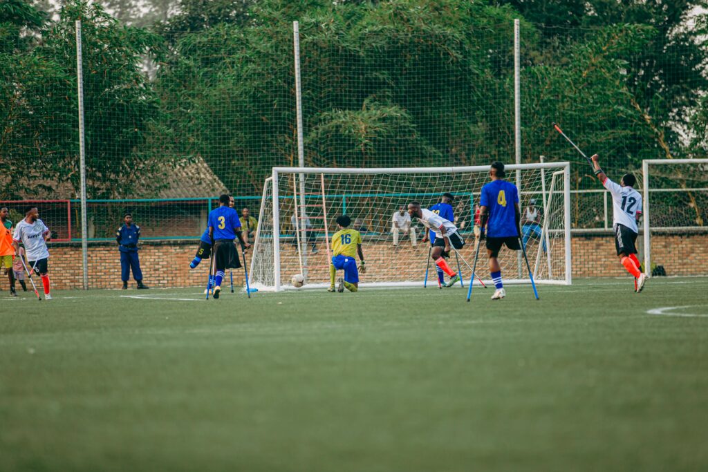 Amputee football match showcasing players in action on a sunny day, emphasizing inclusivity in sports.